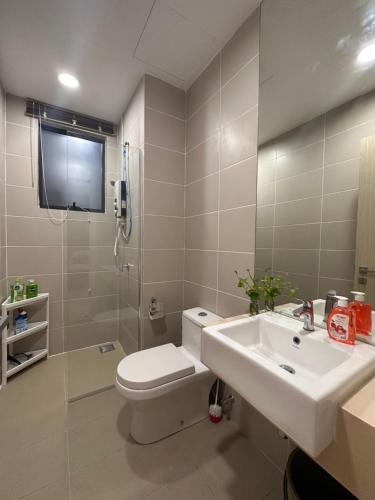 a bathroom with a toilet and a sink at Stylish Urban Oasis Icon City with Sky Pool and Cozy Interior in Petaling Jaya
