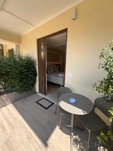 a patio with a table and chairs and a bed at Residenza Gurnea - Free Private Parking in Tropea