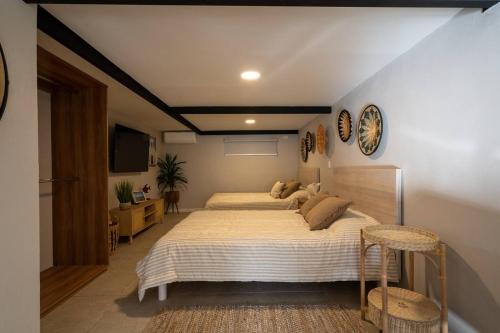 a bedroom with a large bed and two chairs at Ocean Home Sweet Home - Suite 1 in Rosarito