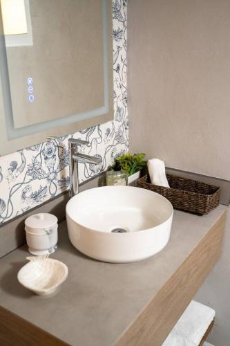 a bathroom with a white sink and a mirror at Ocean Home Sweet Home - Suite 1 in Rosarito