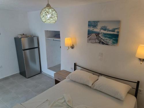 a bedroom with a bed and a refrigerator at Silver View Aprovato in Apróvaton