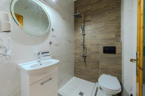 a bathroom with a shower and a toilet and a sink at Villa Vasiliki in Skala Potamias