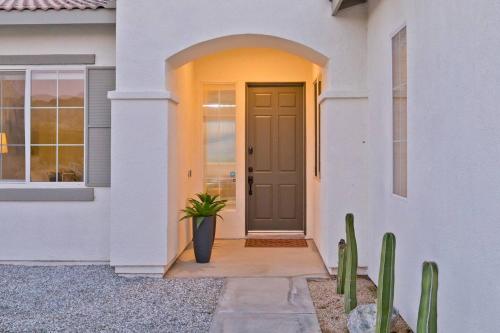 a front door of a house with a potted plant at Ridge Overlook | Stunning Mountain Views in Desert Hot Springs