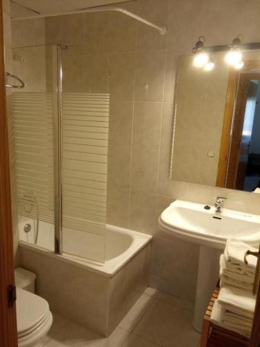 a bathroom with a tub and a sink and a toilet at Casa Nando in Esterri d'Àneu