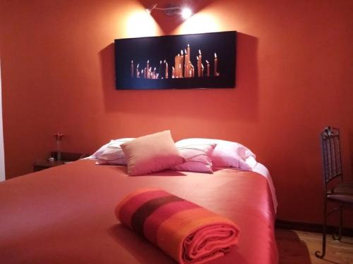 a bedroom with a bed with a tv on the wall at Hotel Casa Ecuatreasures Centro Historico in Quito
