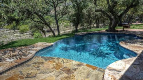 a swimming pool in a yard with trees at Fryars' Villa in Concan