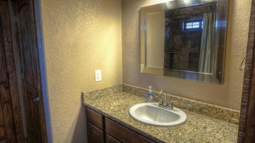 a bathroom with a sink and a mirror at Fryars' Villa in Concan