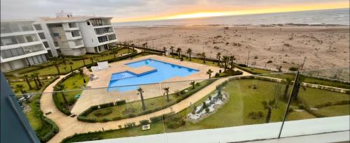 a view of a swimming pool and the beach at Ocean Therapy in Dar Oulad Hajj Kassem