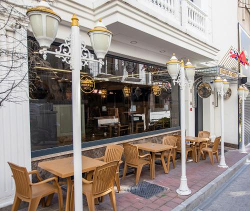 a row of tables and chairs in front of a restaurant at Morava Hotel in Istanbul