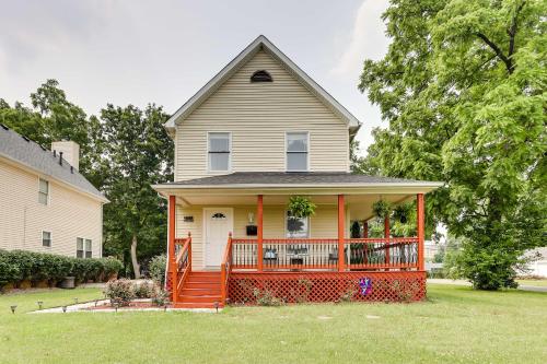 a house with a large orange front porch at Walkable Apt Near Kentucky Derby! in Louisville