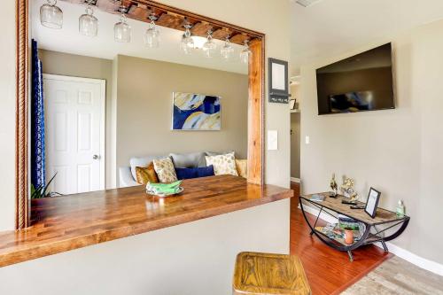 a living room with a mirror and a couch at Walkable Apt Near Kentucky Derby! in Louisville