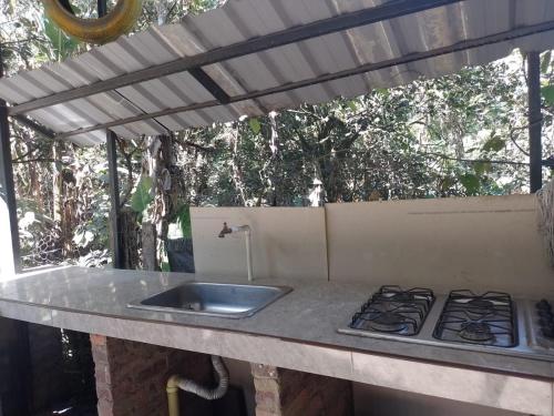 a kitchen counter with a sink and a stove at Claro de Luna in San Francisco