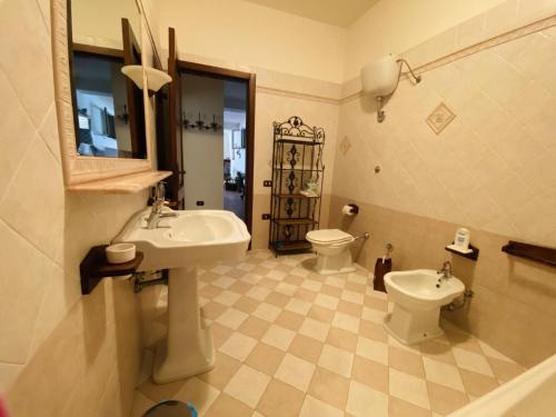 a bathroom with a sink and a toilet and a mirror at Uva Malvasia in Il Monte