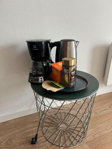 - une table avec une cafetière et une tasse de café dans l'établissement Studio situé à la gare proche Paris orly, à Quincy-sous-Sénart