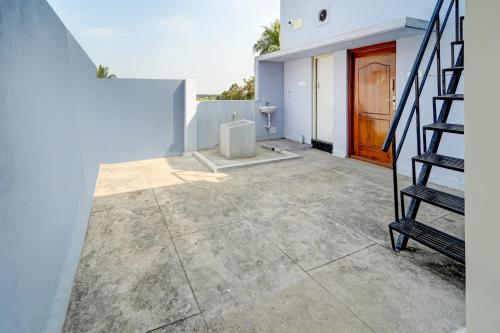 a stairway leading to a house with a door at Hotel O MM Home Stays in Irugūr