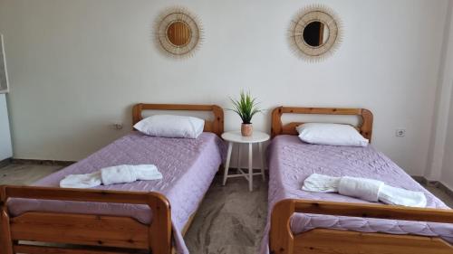 two beds sitting next to each other in a room at Tolo Blue Bay in Tolo