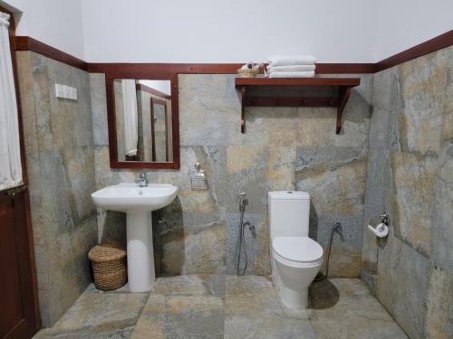 a bathroom with a toilet and a sink at Pinnacle of Everything in Kandy