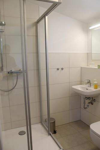 a bathroom with a shower and a sink at Pension König in Kassel