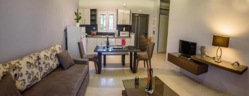a living room with a couch and a table at Ionion Beach Apartment Hotel & Spa in Arkoudi