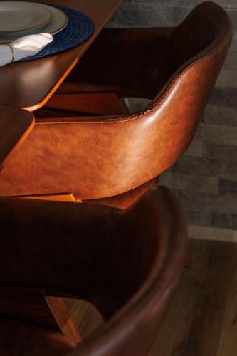 a wooden chair with a table and a plate on it at Almareia Boutique Hotel in Praia dos Carneiros