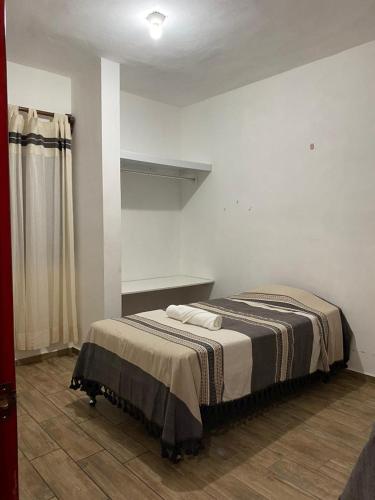 a bedroom with a bed in a room at Casa Ba-Al, Bonito departamento a 5 minutos del centro de Oaxaca in Oaxaca City