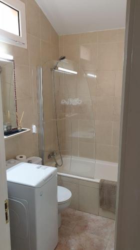 a bathroom with a shower and a toilet and a sink at Bungalow Maspalomas in Maspalomas