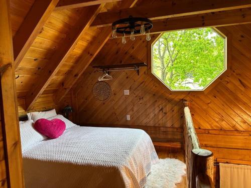 a bedroom with a white bed with a heart pillow at Back to Creek, Pool Table, Firepit & Grill in Cosby