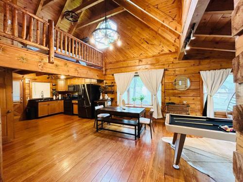 a living room with a piano in a log cabin at Back to Creek, Pool Table, Firepit & Grill in Cosby