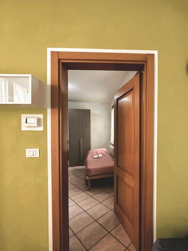 a room with a bedroom with a bed and a door at CASA VACANZE MEDICINA in Medicina