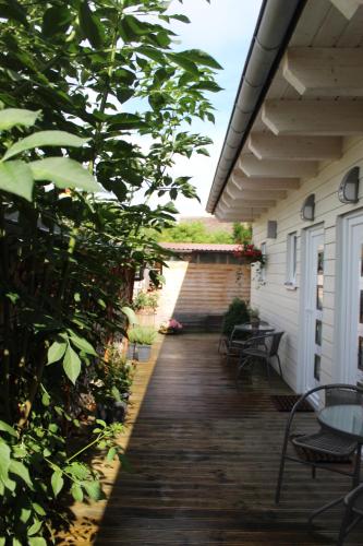 a porch with chairs and tables on a house at Pension König in Kassel