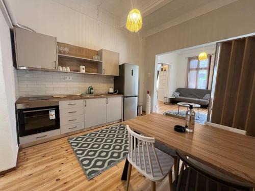 a kitchen with a wooden table and a dining room at Kona Apt Limenaria Thasos in Limenaria