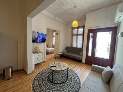 a living room with a couch and a table at Kona Apt Limenaria Thasos in Limenaria
