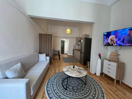 a living room with a couch and a table at Kona Apt Limenaria Thasos in Limenaria