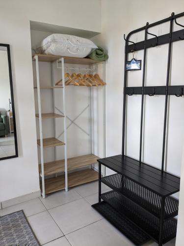 a room with a closet with shelves and a table at Les Jolis Nids - Studio Moineau in La Roche-Posay
