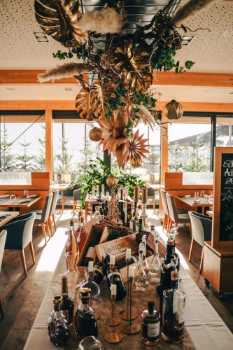 a dining room with a long table with bottles on it at Patrix Hotel, Restaurant, Bar in Frankenburg