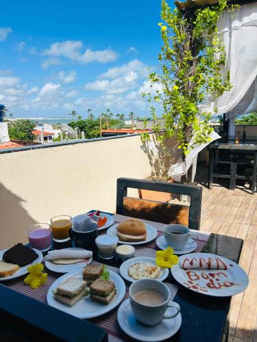 a table topped with plates of food on top of a table at Mansomar in Jericoacoara