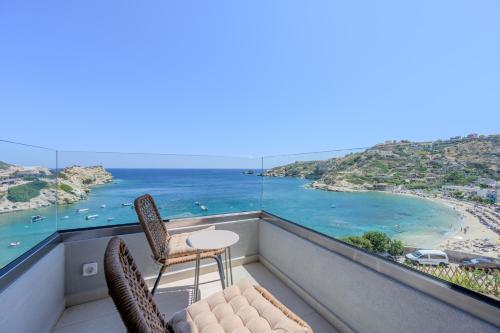 a balcony with chairs and a view of the ocean at Theasea beachfront luxury residence in Ligaria