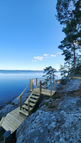 a wooden dock on the shore of a lake at Vänern Lakeside Cliff House in Karlstad