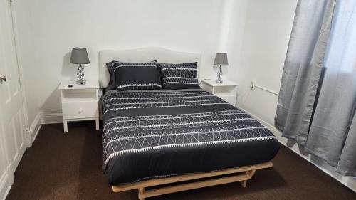 a bedroom with a large bed with two night stands at Eight Street Apartments in Long Beach