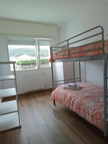 a bedroom with a bunk bed and a ladder at Mar de Queiruga: 11 Illa do Mar in Porto do Son