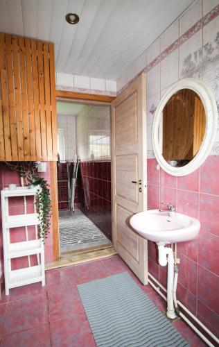 a bathroom with a sink and a mirror at Esplanaadi Villa in Pärnu