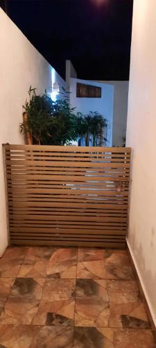 a large wooden fence in a room with plants at Casa Cháak in Caucel