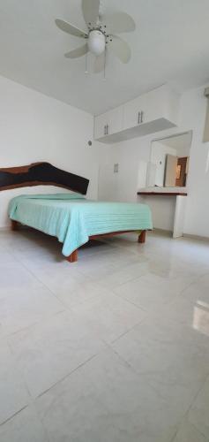 a bed in a white room with a ceiling at Casa Cháak in Caucel