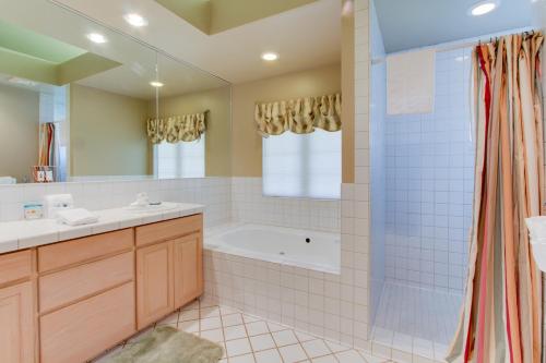 a bathroom with a tub and a sink and a shower at Beach Hideaway in Bandon
