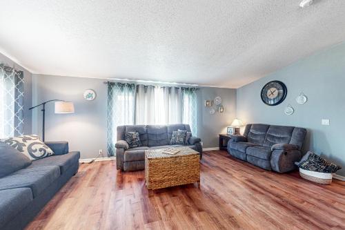 a living room with two couches and a table at Reedsport Coastal Retreat in Reedsport