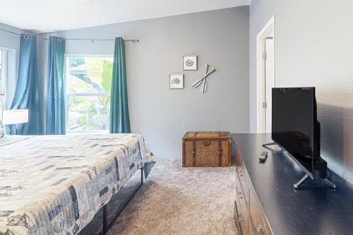 a bedroom with a bed and a television on a table at Reedsport Coastal Retreat in Reedsport