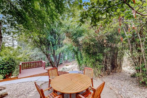 a wooden table and chairs with a bench and trees at Salem Vista Escape in Salem