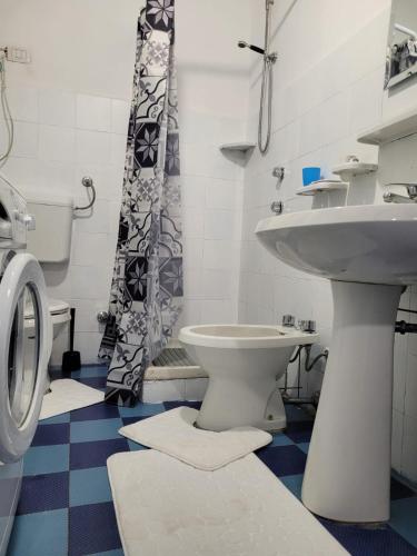 a bathroom with a sink and a toilet at Naxos Beach House in Giardini Naxos