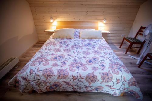 a bedroom with a large bed with a floral bedspread at Lauku iela 25 in Jūrmala