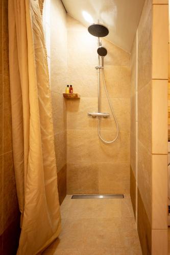 a shower with a shower curtain in a bathroom at Lauku iela 25 in Jūrmala